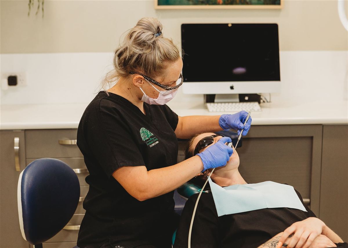 A Southside Dental clinician providing gentle care to a patient in a Toowoomba treatment room